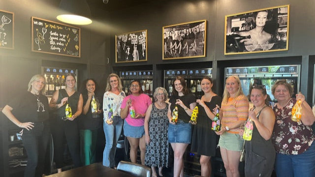 class members holding their handpainted bottles
