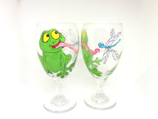 two water goblets with a frog catching a fly