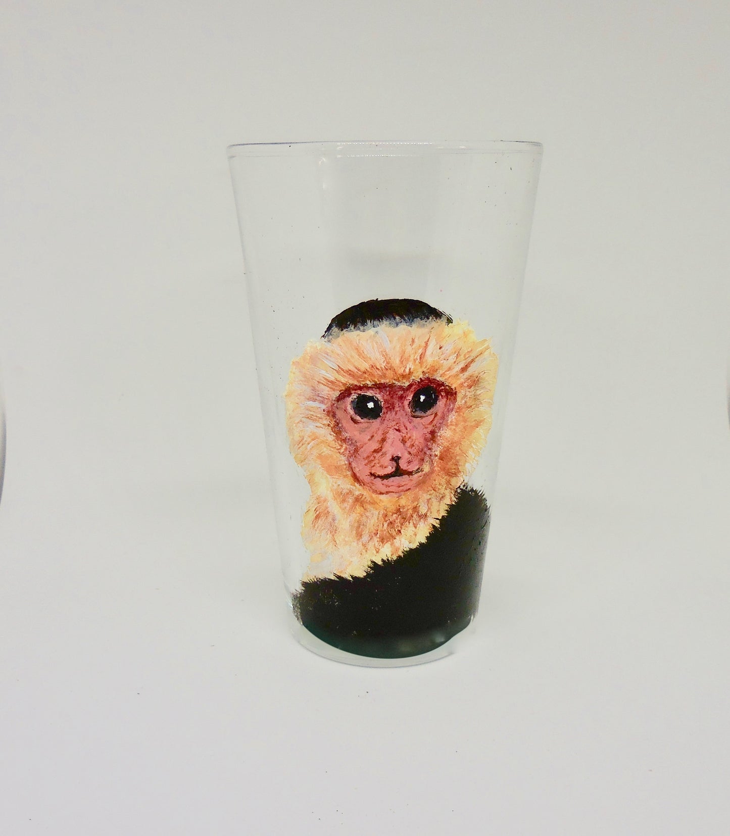 tall glass with capuchin monkey