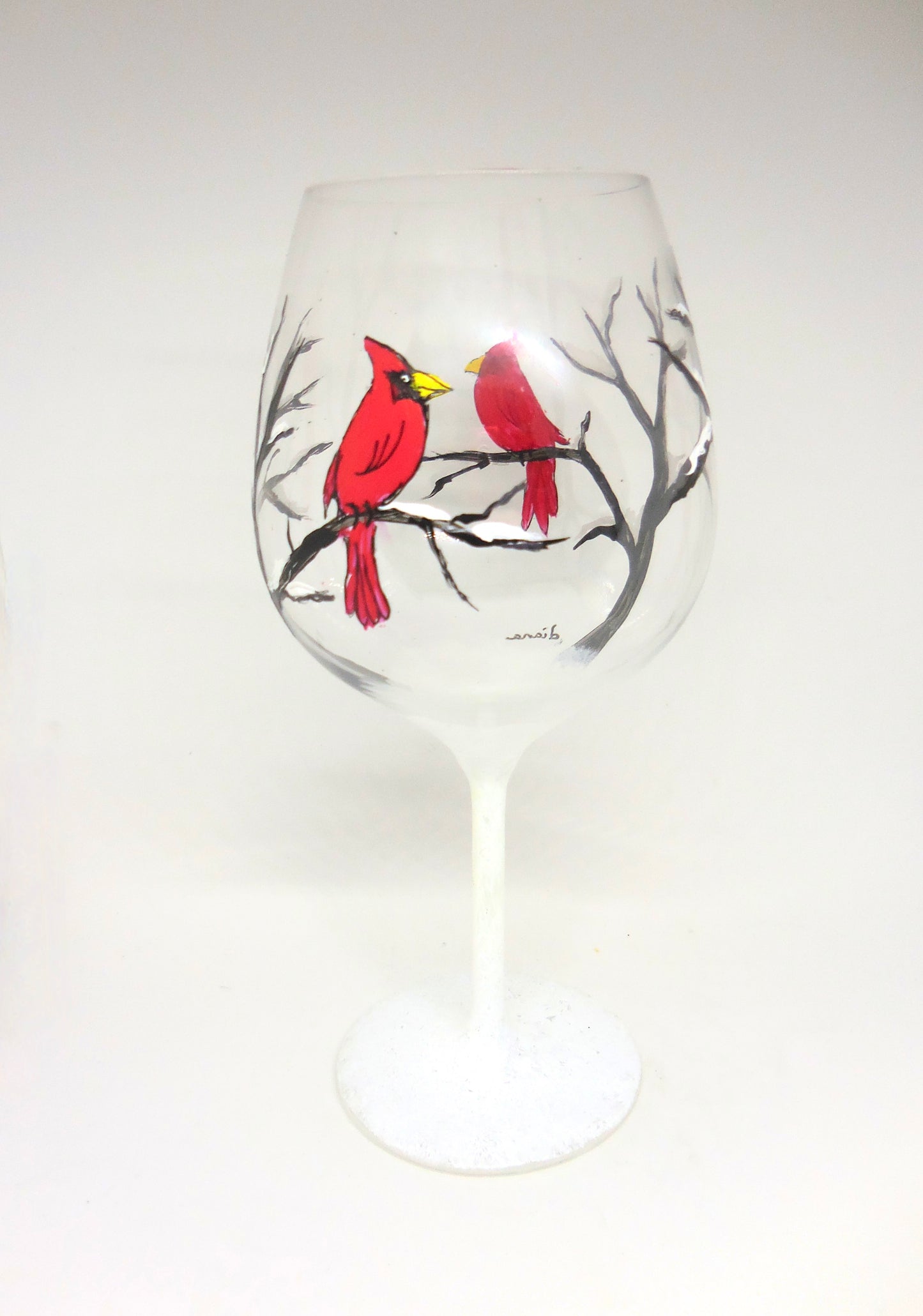 wine glass with cardinal in snow