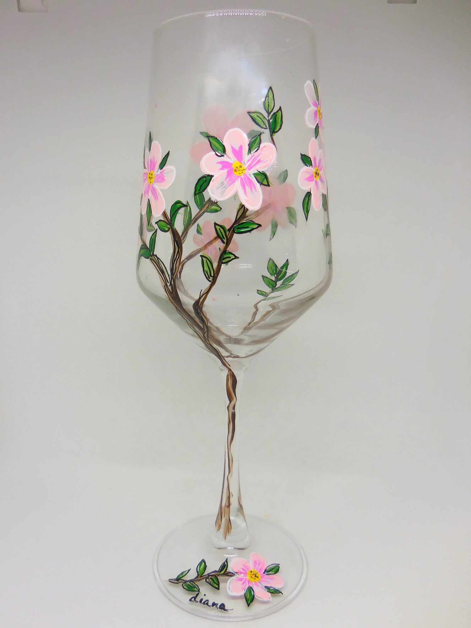 Wine glass with floral design on a white background