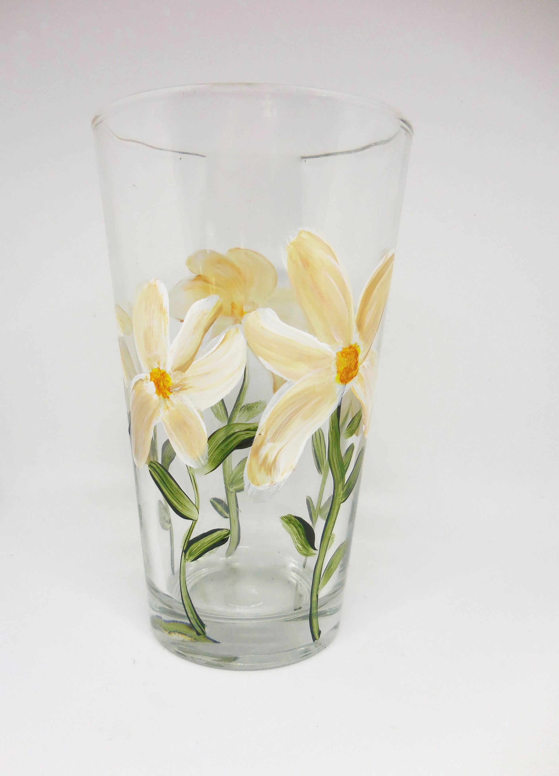 tall glass with daisies