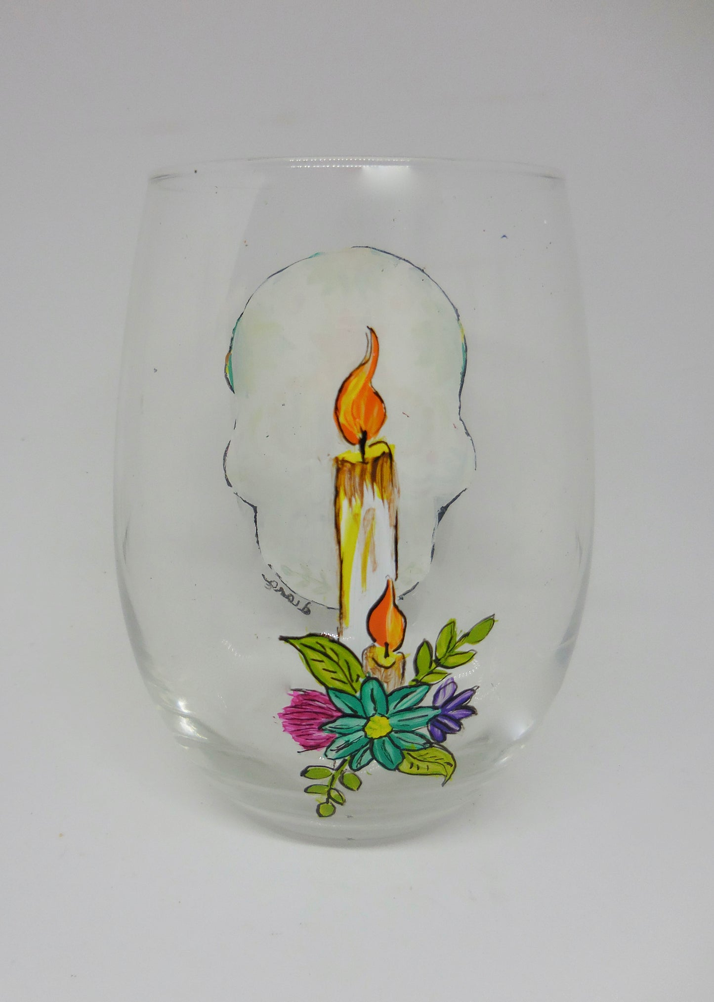 stemless wine glass with day of the dead design and candle