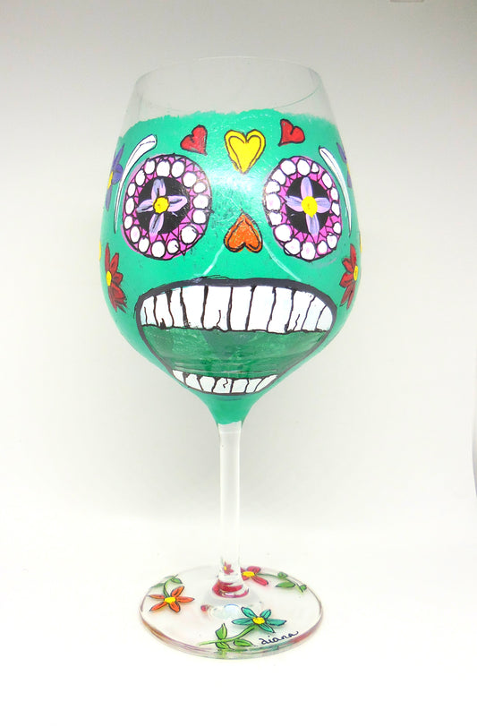 wine glass with green skull design