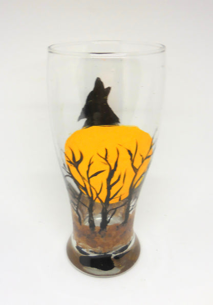 back of beer glass with wolf howling